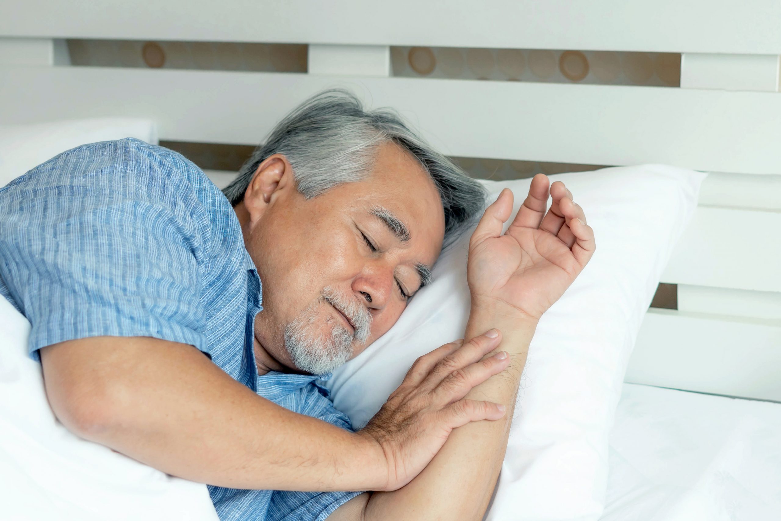 elderly man in bed sleeping