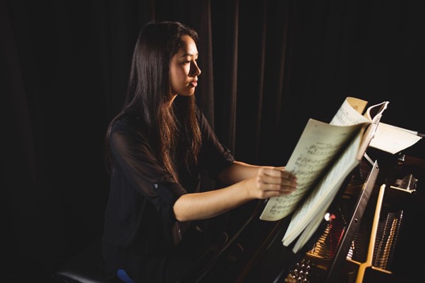A young woman is taking piano lessons in Singapore.